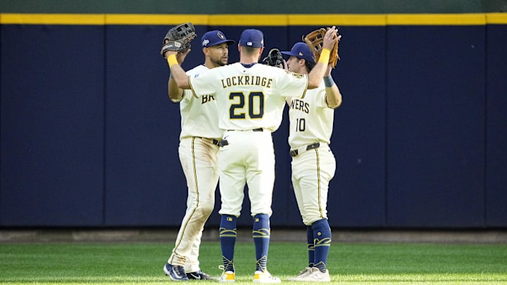 Oct 4, 2025; Milwaukee, Wisconsin, USA; Milwaukee Brewers center fielder Blake Perkins (left), left fielder Brandon Lockridge (20), and right fielder Sal Frelick (10) celebrate after their win against the Chicago Cubs in game one of the NLDS round for the 2025 MLB playoffs at American Family Field. Mandatory Credit: Michael McLoone-Imagn Images