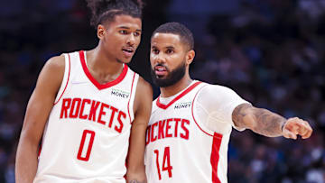 Former Houston Rockets guard D.J. Augustin (14) and guard Jalen Green (0) talk during the fourth quarter against the Dallas Mavericks at American Airlines Center.