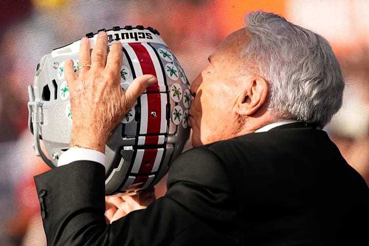 Lee Corso kisses a Buckeye helmet on the set of ESPN College GameDay prior to the NCAA football game between the Ohio State B