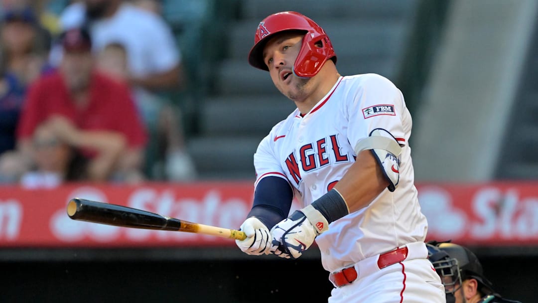 Jul 24, 2025; Anaheim, California, USA;  Los Angeles Angels right fielder Mike Trout (27) singles in the first inning against the Seattle Mariners at Angel Stadium. Mandatory Credit: Jayne Kamin-Oncea-Imagn Images