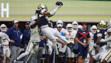 Oct 19, 2024; Atlanta, Georgia, USA; Notre Dame Fighting Irish safety Xavier Watts (0) intercepts a pass in front of Georgia Tech Yellow Jackets wide receiver Abdul Janneh Jr. (4) in the fourth quarter at Mercedes-Benz Stadium. Mandatory Credit: Brett Davis-Imagn Images
