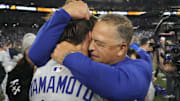 Nov 1, 2025; Toronto, Ontario, CAN; Los Angeles Dodgers pitcher Yoshinobu Yamamoto (18) celebrates with manager Dave Roberts (30) after defeating the Toronto Blue Jays in game seven of the 2025 MLB World Series at Rogers Centre. Mandatory Credit: John E. Sokolowski-Imagn Images