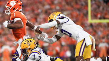 Clemson Tigers wide receiver T.J. Moore (1) is tackled by LSU Tigers linebacker Harold Perkins Jr. (7) and LSU Tigers safety Tamarcus Cooley (0) Saturday, Aug. 30, 2025 during the NCAA football game at Memorial Stadium in Clemson, South Carolina.