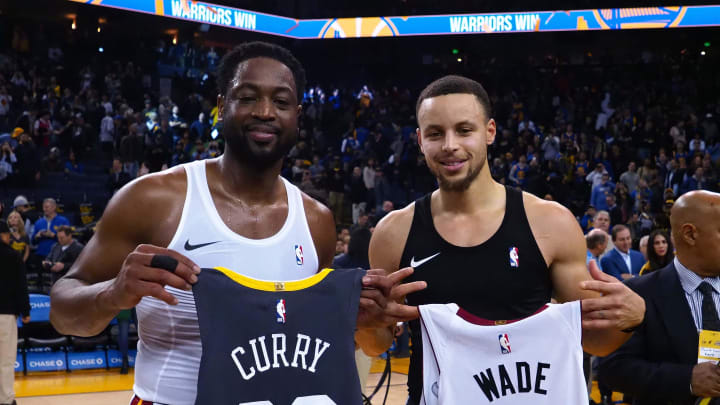 Feb 10, 2019; Oakland, CA, USA; Miami Heat guard Dwyane Wade (3) and Golden State Warriors guard Stephen Curry (30) exchange jerseys after the game at Oracle Arena. Mandatory Credit: Kelley L Cox-USA TODAY Sports