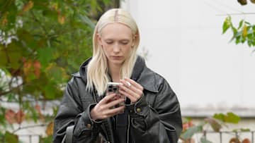 A woman on her phone in the streets of Paris