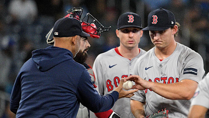 Boston Red Sox manager Alex Cora (13) relieves pitcher Zach Penrod (67) against the Toronto Blue Jays in the 10th inning at Rogers Centre on Sept. 24, 2024. Boston Red Sox manager Alex Cora (13) relieves pitcher Zach Penrod (67) against the Toronto Blue Jays in the 10th inning at Rogers Centre on Sept. 24, 2024.