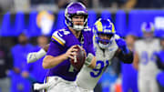 Oct 24, 2024; Inglewood, California, USA; Minnesota Vikings quarterback Sam Darnold (14) runs the ball ahead of Los Angeles Rams defensive tackle Kobie Turner (91) during the second half at SoFi Stadium. 