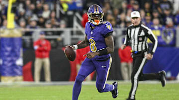 Nov 7, 2024; Baltimore, Maryland, USA; Baltimore Ravens quarterback Lamar Jackson (8) looks to pass on the run during the first quarter  against the Cincinnati Bengals at M&T Bank Stadium. Mandatory Credit: Tommy Gilligan-Imagn Images