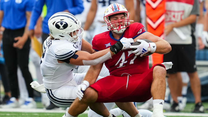 Sep 23, 2023; Lawrence, Kansas, USA; Kansas Jayhawks tight end Jared Casey (47) is tackled by Brigham Young Cougars linebacker Ben Bywater (2) during the first half at David Booth Kansas Memorial Stadium.