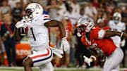 Aug 31, 2024; Tucson, Arizona, USA; Arizona Wildcats running back Jacory Croskey-Merritt (1) runs the ball for a touchdown while New Mexico Lobos safety Christian Ellis (8) chases him during fourth quarter at Arizona Stadium