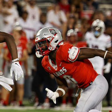 Aug 31, 2024; Tucson, Arizona, USA; Arizona Wildcats running back Jacory Croskey-Merritt (1) runs the ball for a touchdown while New Mexico Lobos safety Christian Ellis (8) chases him during fourth quarter at Arizona Stadium