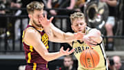 Minnesota Golden Gophers forward Parker Fox (23) and Purdue Boilermakers forward Caleb Furst (1) 