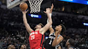 Oct 28, 2024; San Antonio, Texas, USA; Houston Rockets center Alperen Sengun (28) drives to the basket against center Victor Wembanyama (1) during the first half at Frost Bank Center. Mandatory Credit: Scott Wachter-Imagn Images