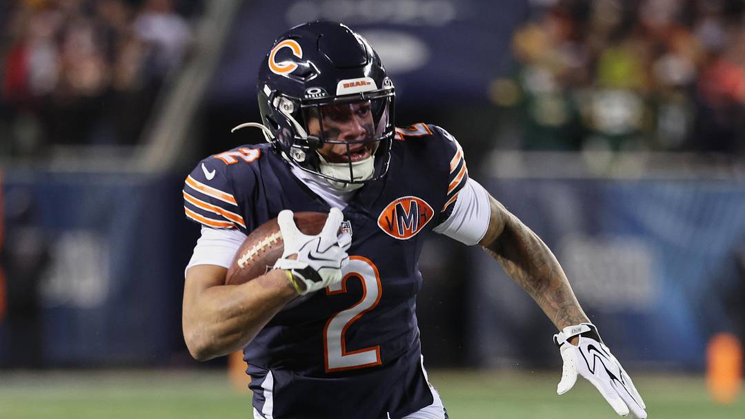 Dec 20, 2025; Chicago, Illinois, USA; Chicago Bears wide receiver DJ Moore (2) runs after the catch against Green Bay Packers guard Lecitus Smith (68) during the first quarter at Soldier Field. Mandatory Credit: Mike Dinovo-Imagn Images
