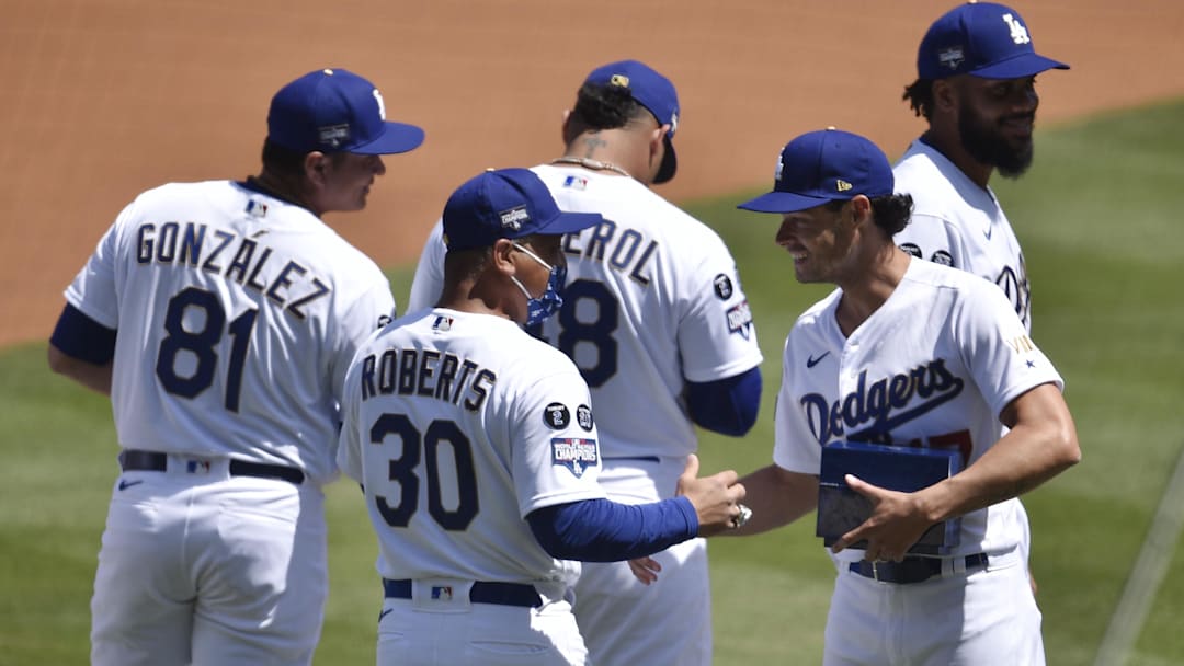 Dodgers pitcher Joe Kelly (17) celebrates with manager Dave Roberts during the 2020 World Series Championship ceremony before the game against the Washington Nationals at Dodger Stadium on April 9, 2021.