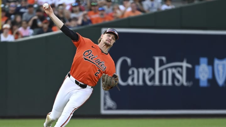 Aug 24, 2024; Baltimore, Maryland, USA;  Baltimore Orioles shortstop Gunnar Henderson (2) falls while throwing to second base during the eighth inning against the Houston Astros at Oriole Park at Camden Yards. 