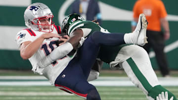Sep 19, 2024; East Rutherford, New Jersey, USA; New England Patriots quarterback Drake Maye (10)  gets sacked hard by New York Jets linebacker Jamien Sherwood (44) in the 4th quarter at MetLife Stadium. Mandatory Credit: Robert Deutsch-Imagn Images