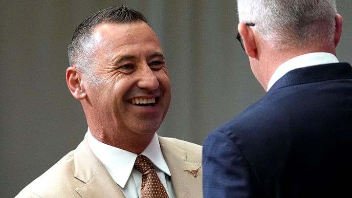 July 15, 2025; Atlanta, GA, USA; Texas head coach Steve Sarkisian shakes hands with Commissioner Greg Sankey during SEC Media Days at the College Football Hall of Fame in Atlanta.