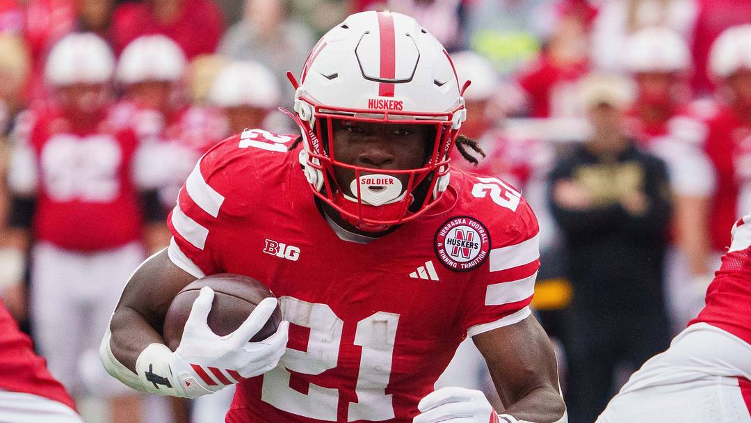 Oct 25, 2025; Lincoln, Nebraska, USA; Nebraska Cornhuskers running back Emmett Johnson (21) runs the ball against the Northwestern Wildcats during the first quarter at Memorial Stadium. Mandatory Credit: Dylan Widger-Imagn Images