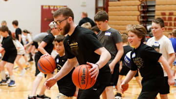 Braden Smith dribbles the ball past kids Saturday, April 19, 2025, during the Braden Smith basketball camp at McCutcheon High School, in Lafayette, Indiana.