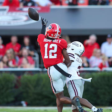Oct 12, 2024; Athens, Georgia, USA; Georgia Bulldogs defensive back Julian Humphrey (12) defends a pass intended for Mississippi State Bulldogs wide receiver Kevin Coleman Jr. (3) in the second quarter at Sanford Stadium. Mandatory Credit: Brett Davis-Imagn Images
