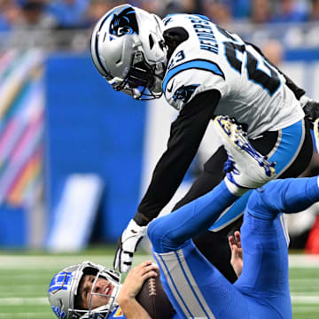 Oct 8, 2023; Detroit, Michigan, USA; Detroit Lions quarterback Jared Goff (16) is sacked by Carolina Panthers cornerback CJ Henderson (23) in the third quarter at Ford Field. Mandatory Credit: Lon Horwedel-Imagn Images