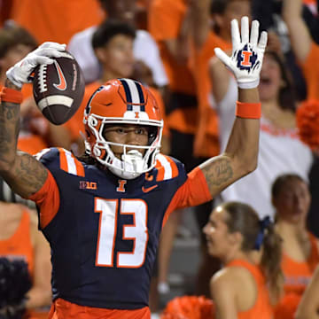 Aug 29, 2024; Champaign, Illinois, USA;  Illinois Fighting Illini wide receiver Pat Bryant (13) celebrates his touchdown during the first half against Eastern Illinois Panthers at Memorial Stadium. Mandatory Credit: Ron Johnson-Imagn Images