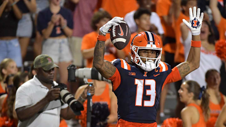 Aug 29, 2024; Champaign, Illinois, USA;  Illinois Fighting Illini wide receiver Pat Bryant (13) celebrates his touchdown during the first half against Eastern Illinois Panthers at Memorial Stadium. Mandatory Credit: Ron Johnson-Imagn Images