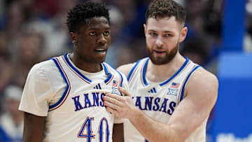 Feb 3, 2025; Lawrence, Kansas, USA; Kansas Jayhawks forward Flory Bidunga (40) and center Hunter Dickinson (1) react during the second half against the Iowa State Cyclones at Allen Fieldhouse. Mandatory Credit: Jay Biggerstaff-Imagn Images