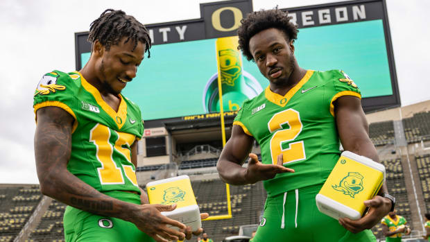 Tez Johnson (left) and Jeffrey Bassa (right) pose with the Oregon Beats by Dre Headphones at Autzen Stadium.