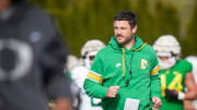 Oregon head coach Dan Lanning runs during practice with the Ducks Thursday, April 11, 2024, at the Hatfield-Dowlin Complex in Eugene, Ore.