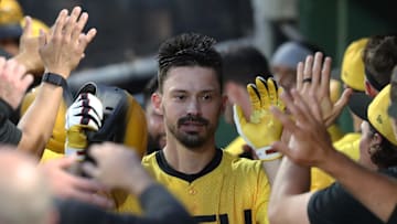 Jun 27, 2025; Pittsburgh, Pennsylvania, USA;  Pittsburgh Pirates right fielder Bryan Reynolds (10) celebrates in the dugout after hitting a three run home run against the New York Mets during the sixth inning at PNC Park. Mandatory Credit: Charles LeClaire-Imagn Images