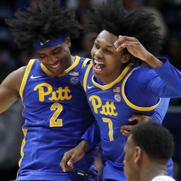 Feb 17, 2024; Pittsburgh, Pennsylvania, USA;  Pittsburgh Panthers forward Blake Hinson (2) and guard Carlton Carrington (7) celebrate after Hinson hit a three point basket to break the forty point mark against the Louisville Cardinals during the second half at the Petersen Events Center. Pittsburgh won 86-59. Mandatory Credit: Charles LeClaire-USA TODAY Sports