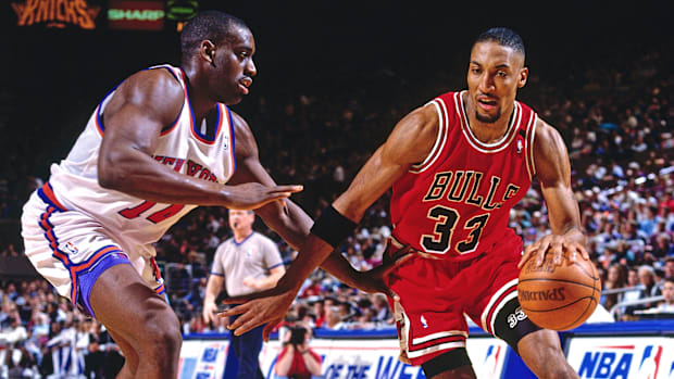 Bulls forward Scottie Pippen dribbles past a New York Knicks defender during a game.