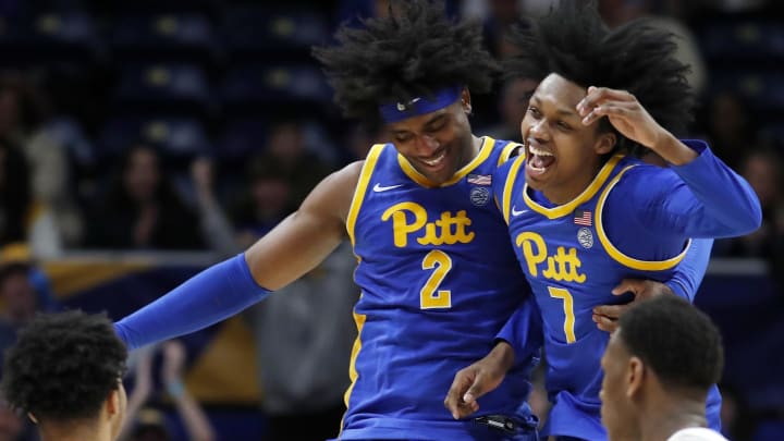 Feb 17, 2024; Pittsburgh, Pennsylvania, USA;  Pittsburgh Panthers forward Blake Hinson (2) and guard Carlton Carrington (7) celebrate after Hinson hit a three point basket to break the forty point mark against the Louisville Cardinals during the second half at the Petersen Events Center. Pittsburgh won 86-59. Mandatory Credit: Charles LeClaire-USA TODAY Sports