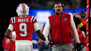 Dec 1, 2025; Foxborough, Massachusetts, USA; New England Patriots wide receiver Kayshon Boutte (9) high-fives New England Patriots head coach Mike Vrabel on the sideline during the third quarter at Gillette Stadium. Mandatory Credit: David Butler II-Imagn Images