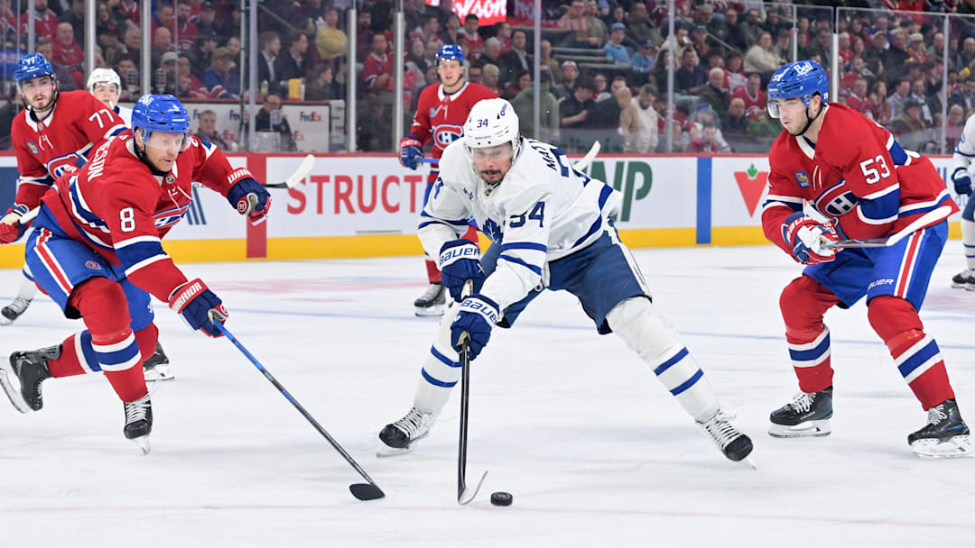 Mar 10, 2026; Montreal, Quebec, CAN; Toronto Maple Leafs forward Auston Matthews (34) plays the puck against Montreal Canadiens defensemen Mike Matheson (8) and Noah Dobson (53) during the third period at the Bell Centre. Mandatory Credit: Eric Bolte-Imagn Images