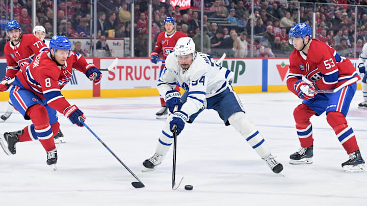 Mar 10, 2026; Montreal, Quebec, CAN; Toronto Maple Leafs forward Auston Matthews (34) plays the puck against Montreal Canadiens defensemen Mike Matheson (8) and Noah Dobson (53) during the third period at the Bell Centre. Mandatory Credit: Eric Bolte-Imagn Images