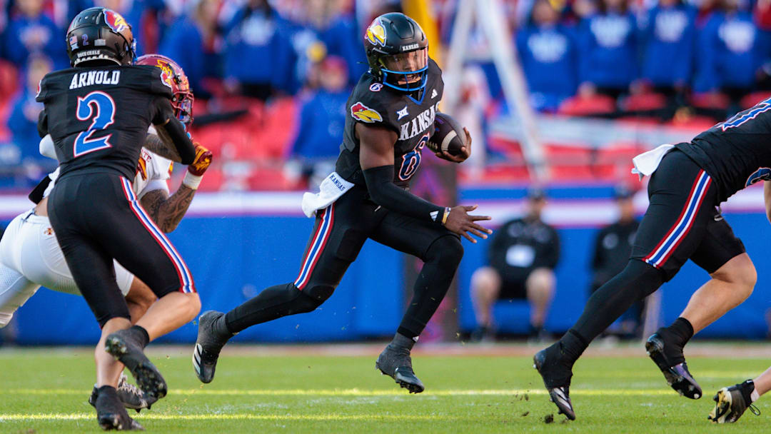 Nov 9, 2024; Kansas City, Missouri, USA; Kansas Jayhawks quarterback Jalon Daniels (6) runs the ball during the second quarter against the Iowa State Cyclones at GEHA Field at Arrowhead Stadium. Mandatory Credit: William Purnell-Imagn Images