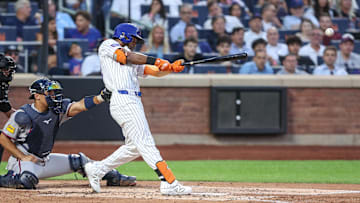 Aug 12, 2025; New York City, New York, USA;  New York Mets center fielder Cedric Mullins (28) hits an RBI single in the second inning against the Atlanta Braves at Citi Field. Mandatory Credit: Wendell Cruz-Imagn Images