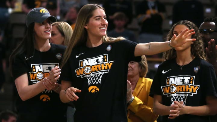 Iowa’s Kate Martin waves at the crowd during a celebration 