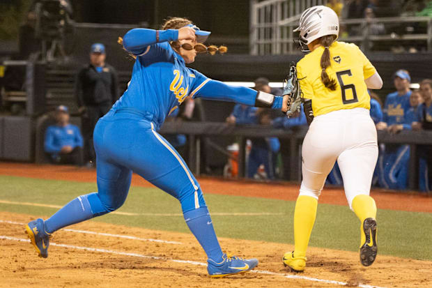 Oregon infielder Katie Flannery is tagged out by UCLA utility Megan Grant