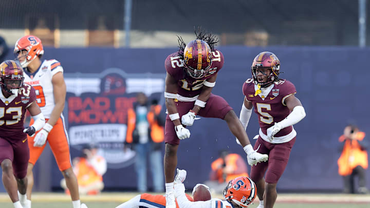 Dec 29, 2022; Bronx, NY, USA; Minnesota Golden Gophers defensive back Darius Green (12) reacts after stopping Syracuse Orange wide receiver Trebor Pena (2) on fourth down during the second quarter of the 2022 Pinstripe Bowl at Yankee Stadium. Mandatory Credit: Brad Penner-Imagn Images