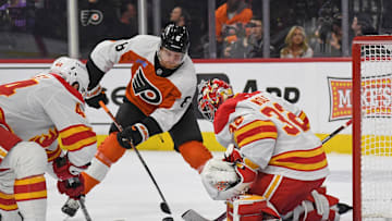 Mar 4, 2025; Philadelphia, Pennsylvania, USA; Philadelphia Flyers defenseman Cam York (8) takes shot on Calgary Flames goaltender Dustin Wolf (32) during the first period at Wells Fargo Center.