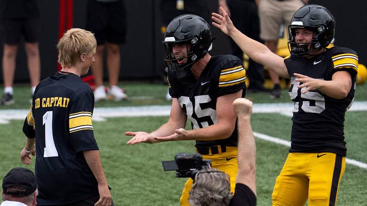 Iowa punter Tanner Philpott (35) and Iowa place kicker Eli Ozick (25) react after Kid Captain Isaac Raue made a field goal Aug. 15, 2026 during the Kids Day at Kinnick open practice at Kinnick Stadium in Iowa City, Iowa.