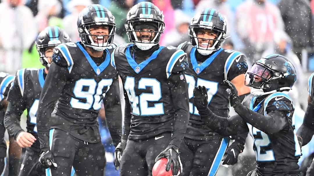 Carolina Panthers special teams players Amare Barno (90), Sam Franklin Jr. (42), Alex Cook (27), and Jammie Robinson (22) react in the first quarter at Bank of America Stadium.