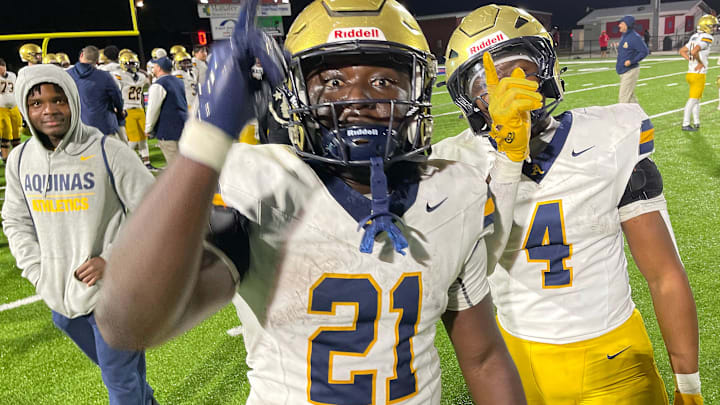 St. Thomas Chance Washington (#21) and Cedric Wyche (#4) celebrate the three-point win. St. Thomas Aquinas defeated the Manatee Hurricanes 16-13 on Friday night, in Bradenton to advance to state championship.