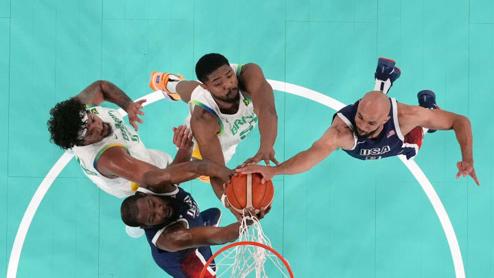 Aug 6, 2024; Paris, France; United States forward Kevin Durant, guard Derrick White against Brazil power forward Bruno Caboclo in a men’s basketball quarterfinal game during the Paris 2024 Olympic Summer Games at Accor Arena. 