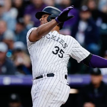 Aug 9, 2024; Denver, Colorado, USA; Colorado Rockies catcher Elias Diaz (35) hits an RBI double in the fourth inning against the Atlanta Braves at Coors Field. Mandatory Credit: Isaiah J. Downing-USA TODAY Sports