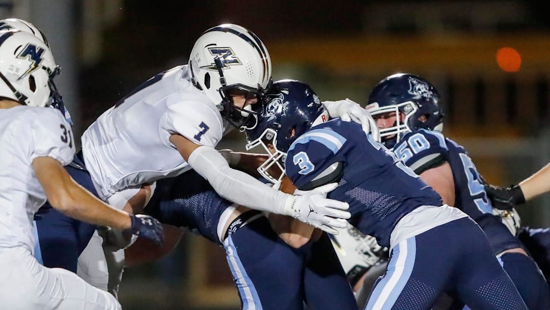 Appleton North High School's Ben Wenzel (7) meets Bay Port High School's Tommy Kemen (3) in the hole during a WIAA Division 1 first round playoff game on Friday, October 24, 2025, at Bay Port High School in Suamico, Wis. Bay Port won the game, 41-6.